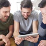 friends browsing photos from their old times