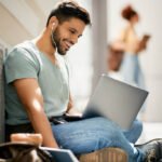 happy college student learning while using laptop 2023 11 27 04 48 59 utc.jpg